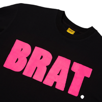 Detail image of Black tee with pink logo reading BRAT