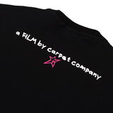 Back of black tee with text reading a FIM by carpet company