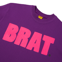 Detail image of Purple tee with pink logo reading BRAT