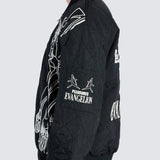 Male wearing black bomber jacket with cartoon imagery and dual branding on the sleeve 