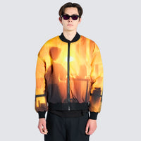 Male wearing orange bomber jacket with cartoon imagery