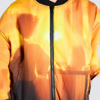 Male wearing orange bomber jacket with cartoon imagery